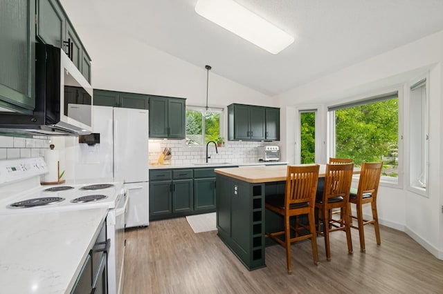 409 Birch Ave NW, Saint Michael, MN 55376 - kitchen with white range with electric stovetop, stainless steel microwave, green cabinetry, lofted ceiling, and light wood-style flooring