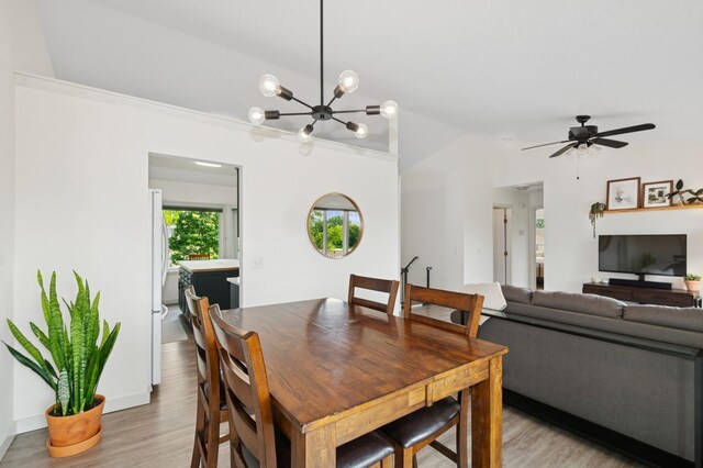 409 Birch Ave NW, Saint Michael, MN 55376 - dining room with light wood finished floors, a chandelier, and a ceiling fan
