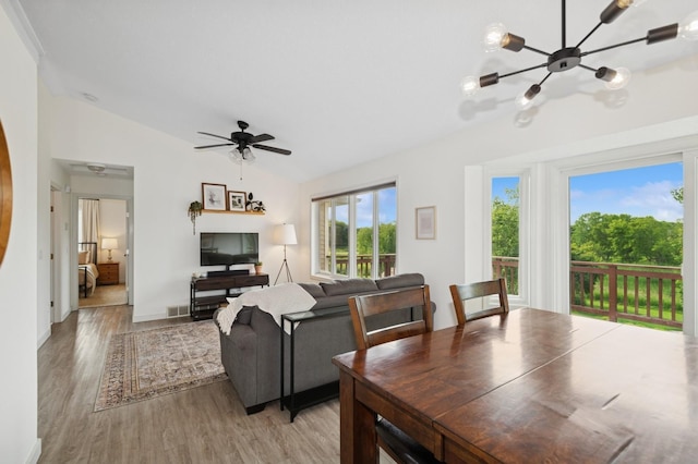409 Birch Ave NW, Saint Michael, MN 55376 - dining area with vaulted ceiling, light wood-type flooring, and a chandelier