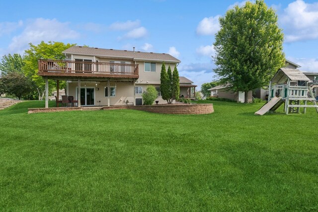 409 Birch Ave NW, Saint Michael, MN 55376 - back of house with a wooden deck, a lawn, and a playground