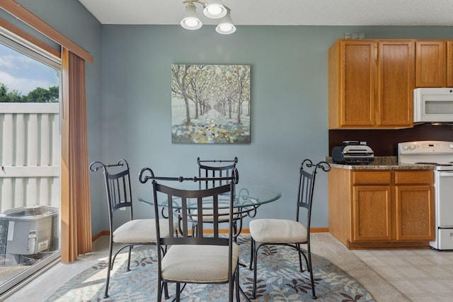 7308 Unity Ln N, Brooklyn Park, MN 55443 - dining area featuring light floors and baseboards