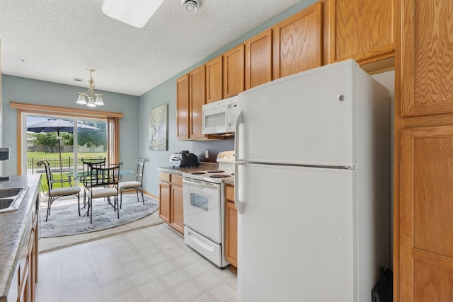 7308 Unity Ln N, Brooklyn Park, MN 55443 - kitchen featuring white appliances, light floors, a chandelier, pendant lighting, and a textured ceiling