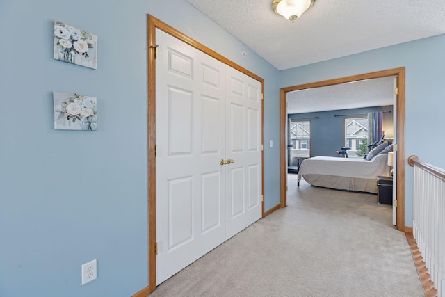 7308 Unity Ln N, Brooklyn Park, MN 55443 - bedroom featuring a textured ceiling, carpet, and a closet