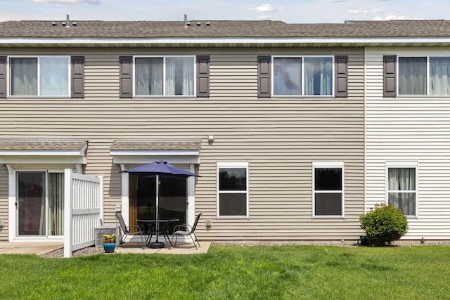 7308 Unity Ln N, Brooklyn Park, MN 55443 - rear view of house with a patio and a lawn