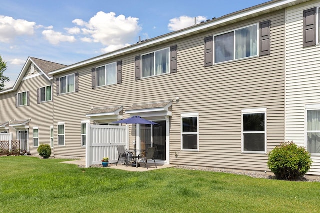 7308 Unity Ln N, Brooklyn Park, MN 55443 - back of house featuring a yard and a patio area