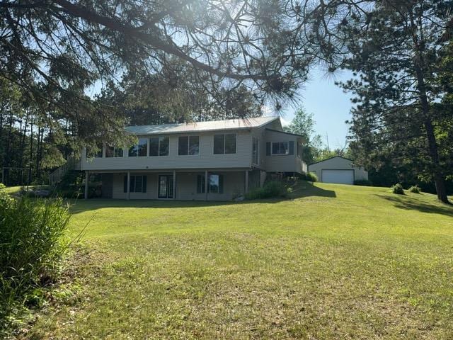 7300 County Road 8 NE, Longville, MN 56655 - view of front of home featuring a garage, a front lawn, and an outdoor structure