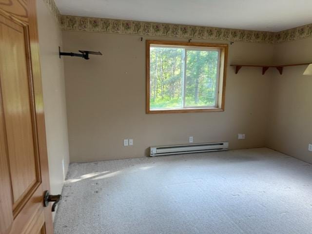 7300 County Road 8 NE, Longville, MN 56655 - spare room with a baseboard heating unit and carpet floors