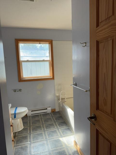 7300 County Road 8 NE, Longville, MN 56655 - full bathroom with baseboard heating and a bathtub