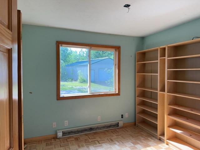 7300 County Road 8 NE, Longville, MN 56655 - empty room with a baseboard radiator and baseboards