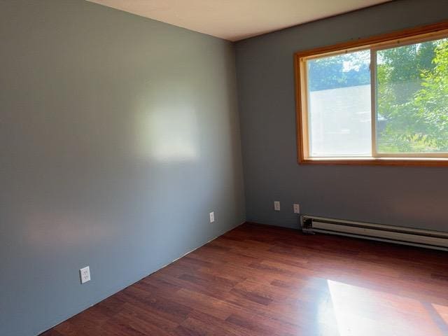 7300 County Road 8 NE, Longville, MN 56655 - empty room featuring a baseboard heating unit and wood finished floors