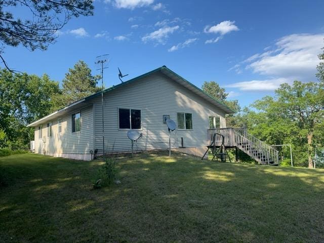 7300 County Road 8 NE, Longville, MN 56655 - back of property featuring a lawn, a deck, and stairs