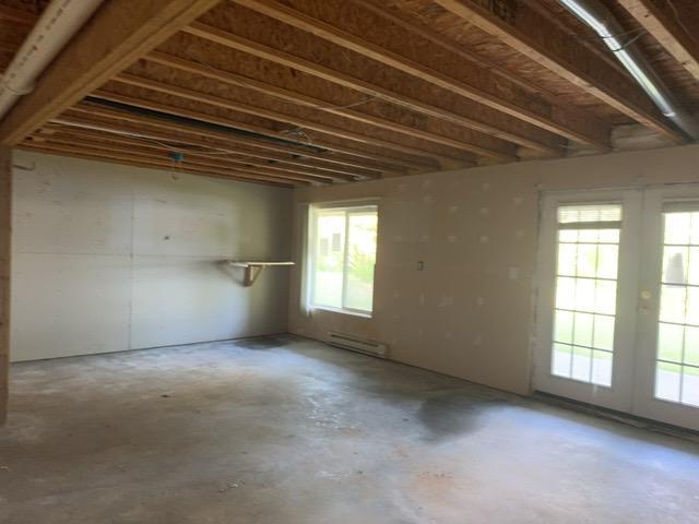 7300 County Road 8 NE, Longville, MN 56655 - misc room featuring french doors, unfinished concrete floors, and a baseboard radiator