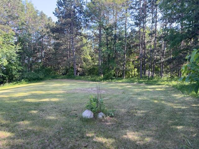 7300 County Road 8 NE, Longville, MN 56655 - view of grassy yard featuring a wooded view