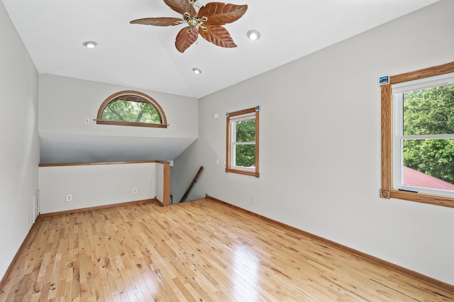 14476 261st Ave NW, Orrock Twp, MN 55398 - empty room featuring healthy amount of natural light, wood-type flooring, lofted ceiling, a ceiling fan, and recessed lighting