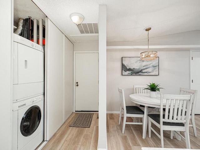 1181 Yuma Ln N, Plymouth, MN 55447 - laundry room with stacked washer / dryer and light wood-style floors