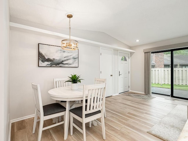 1181 Yuma Ln N, Plymouth, MN 55447 - dining room with vaulted ceiling, light wood-style flooring, and a chandelier