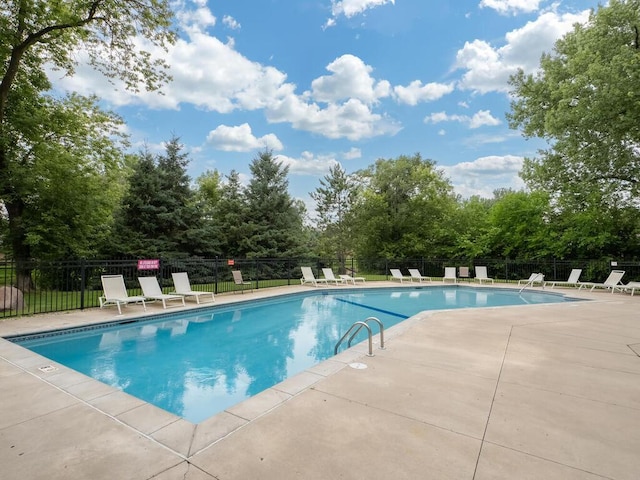 1181 Yuma Ln N, Plymouth, MN 55447 - community pool with a patio and view of wooded area