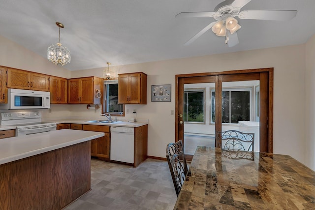 104 9th Ave N, Sartell, MN 56377 - kitchen with white appliances, light floors, a chandelier, and brown cabinetry