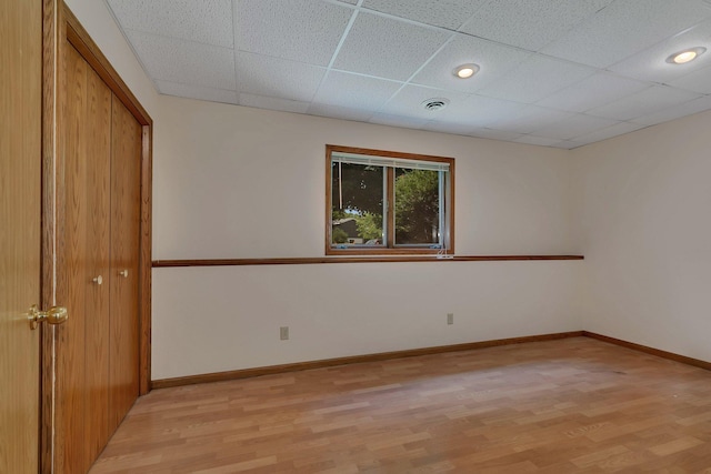 104 9th Ave N, Sartell, MN 56377 - unfurnished bedroom featuring light wood-type flooring, a drop ceiling, and a closet