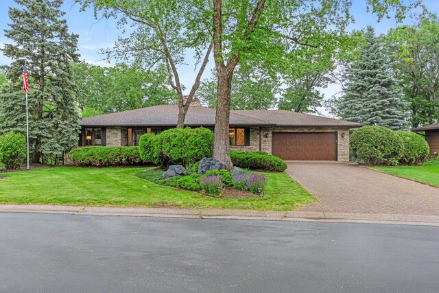 1267 Nursery Hill Ln, Arden Hills, MN 55112 - view of front of home featuring an attached garage, decorative driveway, a front lawn, and brick siding