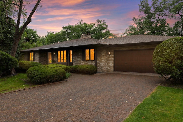 1267 Nursery Hill Ln, Arden Hills, MN 55112 - view of front of property featuring an attached garage, driveway, a chimney, and brick siding