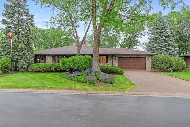 1267 Nursery Hill Ln, Arden Hills, MN 55112 - view of front of home featuring decorative driveway, a garage, a front yard, and brick siding