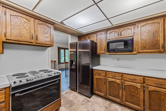 1267 Nursery Hill Ln, Arden Hills, MN 55112 - kitchen featuring black appliances, light countertops, and brown cabinets
