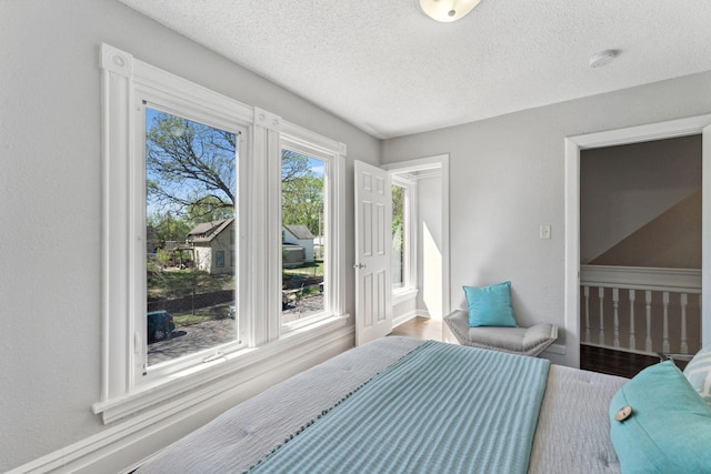 201 Genesee St, Saint Paul, MN 55117 - bedroom with a textured ceiling and wood finished floors