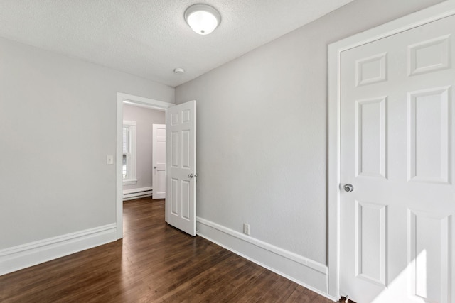 201 Genesee St, Saint Paul, MN 55117 - unfurnished room featuring dark wood-type flooring, a textured ceiling, and a baseboard heating unit