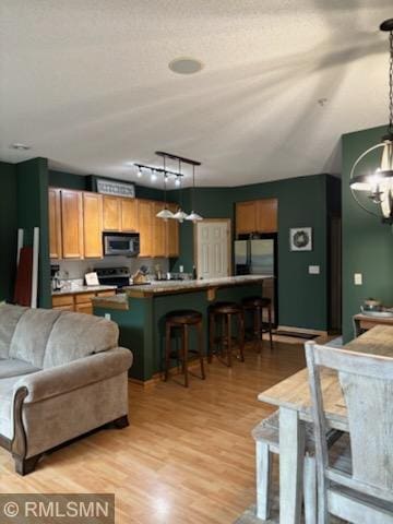 2460 119th Ct NE Unit D, Blaine, MN 55449 - living room with a chandelier, light wood-style floors, and track lighting