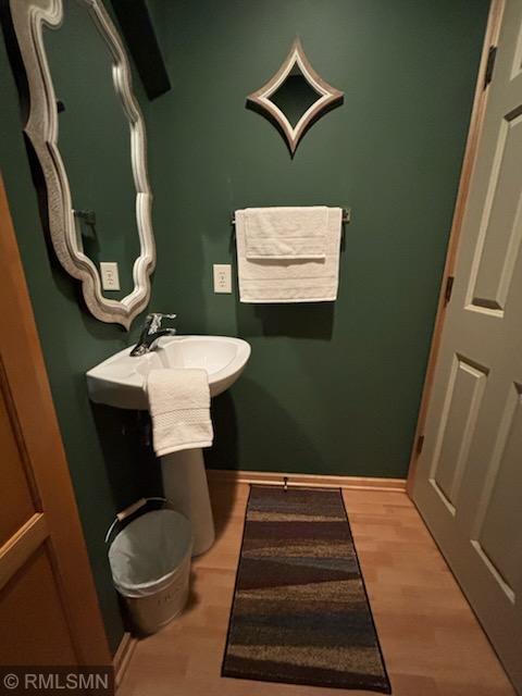 2460 119th Ct NE Unit D, Blaine, MN 55449 - bathroom featuring a sink and wood finished floors