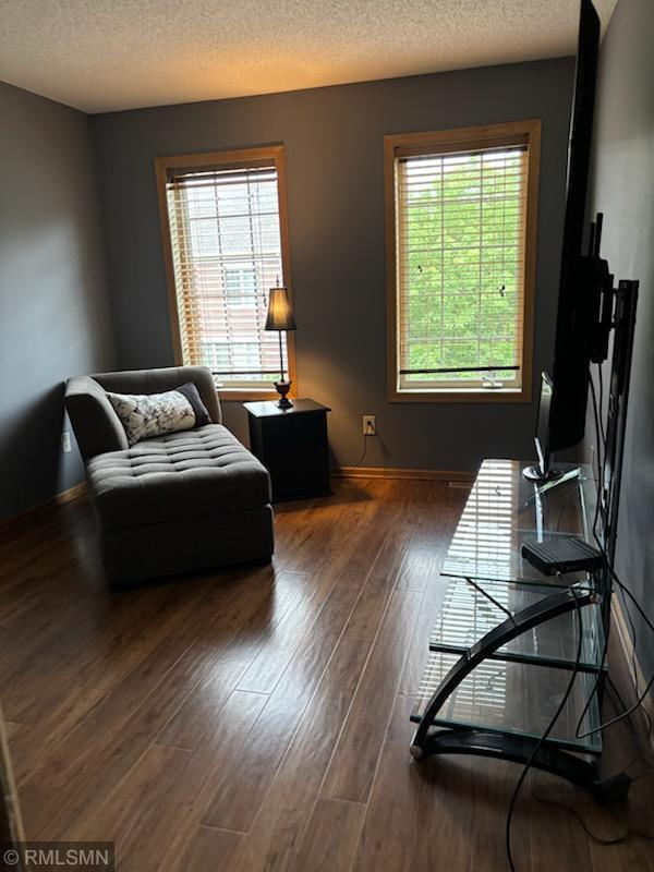 2460 119th Ct NE Unit D, Blaine, MN 55449 - living area featuring wood finished floors and a textured ceiling