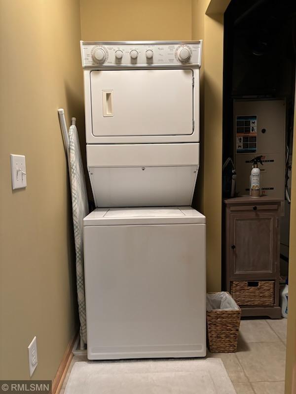 2460 119th Ct NE Unit D, Blaine, MN 55449 - laundry room featuring stacked washer and clothes dryer and light tile patterned flooring