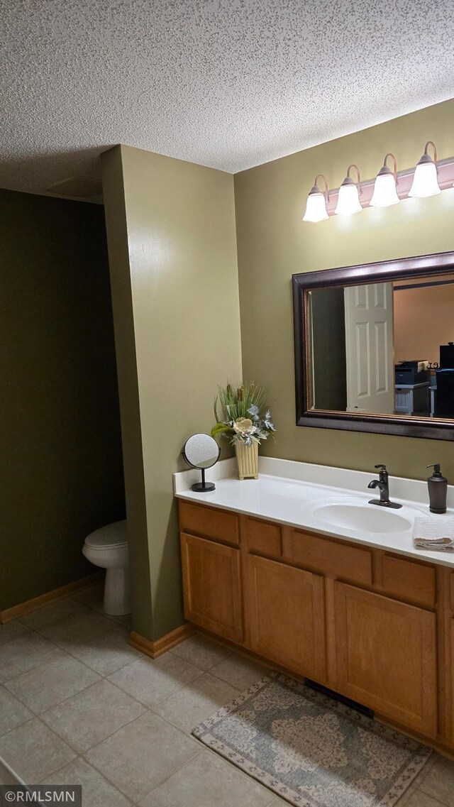 2460 119th Ct NE Unit D, Blaine, MN 55449 - bathroom with vanity, a textured ceiling, and tile patterned floors