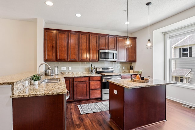 8257 Norwood Ln N, Maple Grove, MN 55369 - kitchen featuring appliances with stainless steel finishes, dark wood-style flooring, tasteful backsplash, light stone countertops, and recessed lighting