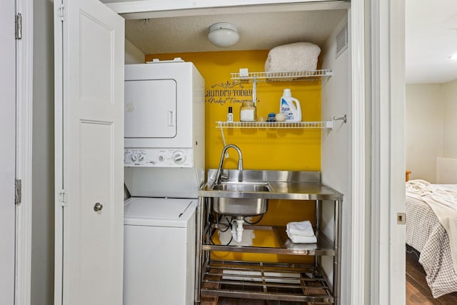 8257 Norwood Ln N, Maple Grove, MN 55369 - washroom featuring stacked washer / drying machine and wood finished floors