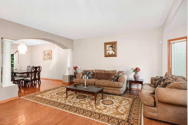 9035 Briarglen Rd, Eden Prairie, MN 55347 - living area featuring decorative columns, wood finished floors, and plenty of natural light
