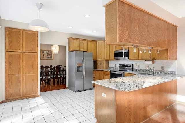 9035 Briarglen Rd, Eden Prairie, MN 55347 - kitchen featuring appliances with stainless steel finishes, a peninsula, tasteful backsplash, light stone countertops, and pendant lighting