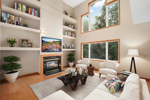 9035 Briarglen Rd, Eden Prairie, MN 55347 - living area with wood finished floors, built in shelves, a fireplace, and a towering ceiling