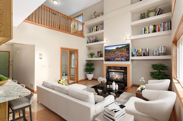 9035 Briarglen Rd, Eden Prairie, MN 55347 - living area featuring a premium fireplace, light wood-style flooring, built in features, and a high ceiling