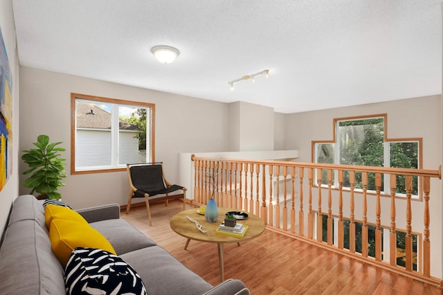9035 Briarglen Rd, Eden Prairie, MN 55347 - living room with wood finished floors, track lighting, and a textured ceiling