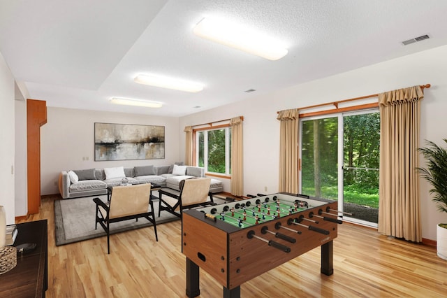 9035 Briarglen Rd, Eden Prairie, MN 55347 - game room with light wood-style flooring and a textured ceiling