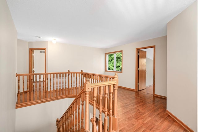9035 Briarglen Rd, Eden Prairie, MN 55347 - corridor featuring an upstairs landing and light wood finished floors