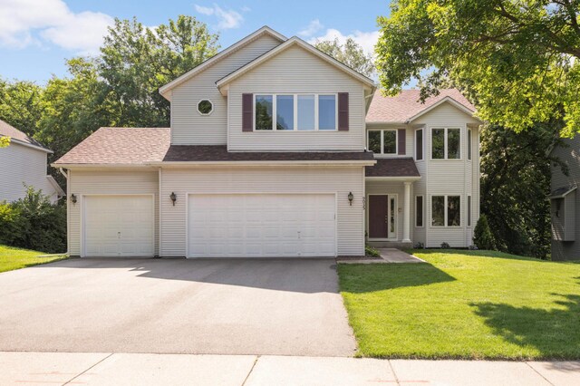 9035 Briarglen Rd, Eden Prairie, MN 55347 - traditional-style home with concrete driveway, a front lawn, a garage, and a shingled roof