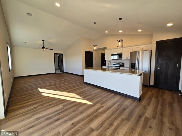 2101 Nelson St, Saint Peter, MN 56082 - kitchen featuring stainless steel appliances, white cabinets, a kitchen island with sink, light stone countertops, and high vaulted ceiling
