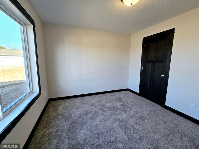 2101 Nelson St, Saint Peter, MN 56082 - carpeted spare room featuring baseboards and a textured ceiling