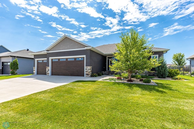 2865 Mcleod Dr E, West Fargo, ND 58078 - view of front of property with a garage, concrete driveway, stucco siding, and stone siding