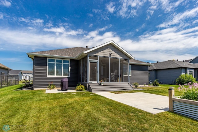 2865 Mcleod Dr E, West Fargo, ND 58078 - back of property featuring a sunroom, a patio, and roof with shingles