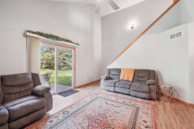 728 Elm St, Belle Plaine, MN 56011 - living room featuring wood finished floors, a high ceiling, and a ceiling fan