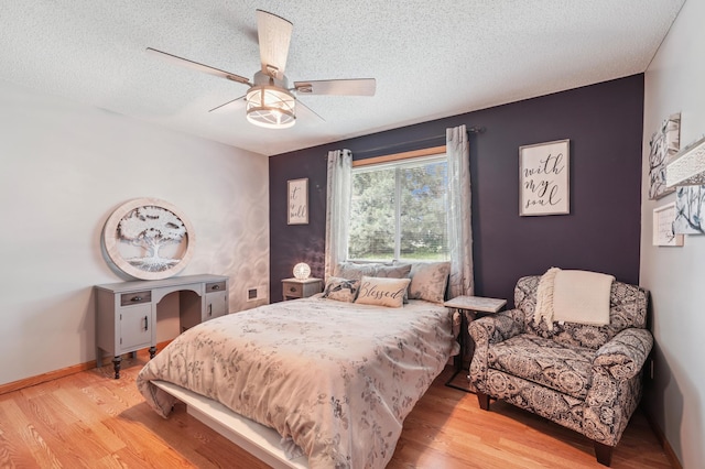 728 Elm St, Belle Plaine, MN 56011 - bedroom featuring wood finished floors, a textured ceiling, and a ceiling fan
